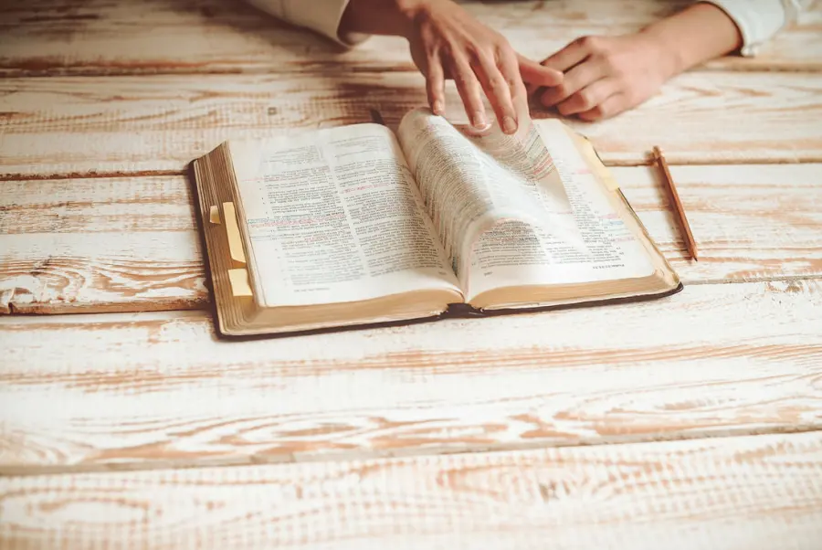 An open Bible on a wooden table